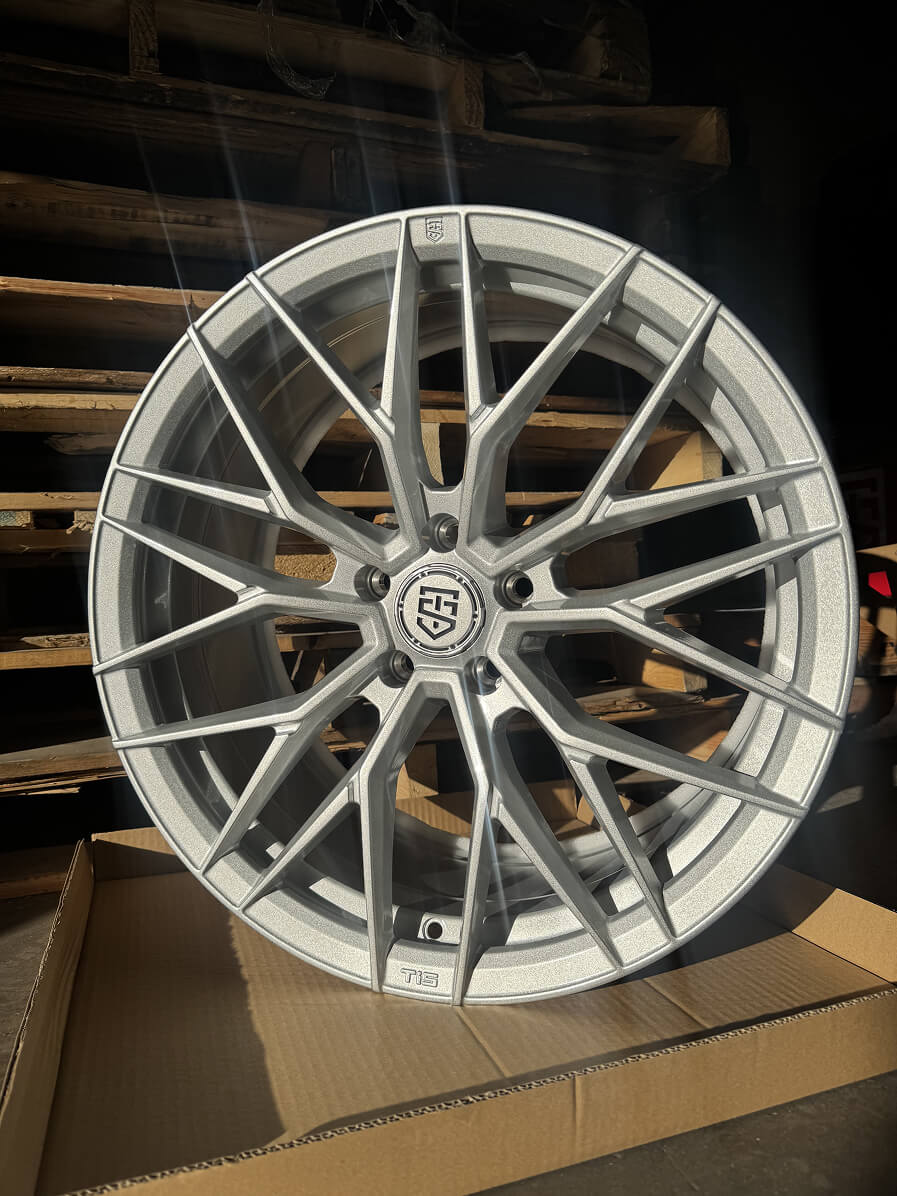 Silver multi-spoke wheel displayed on a box