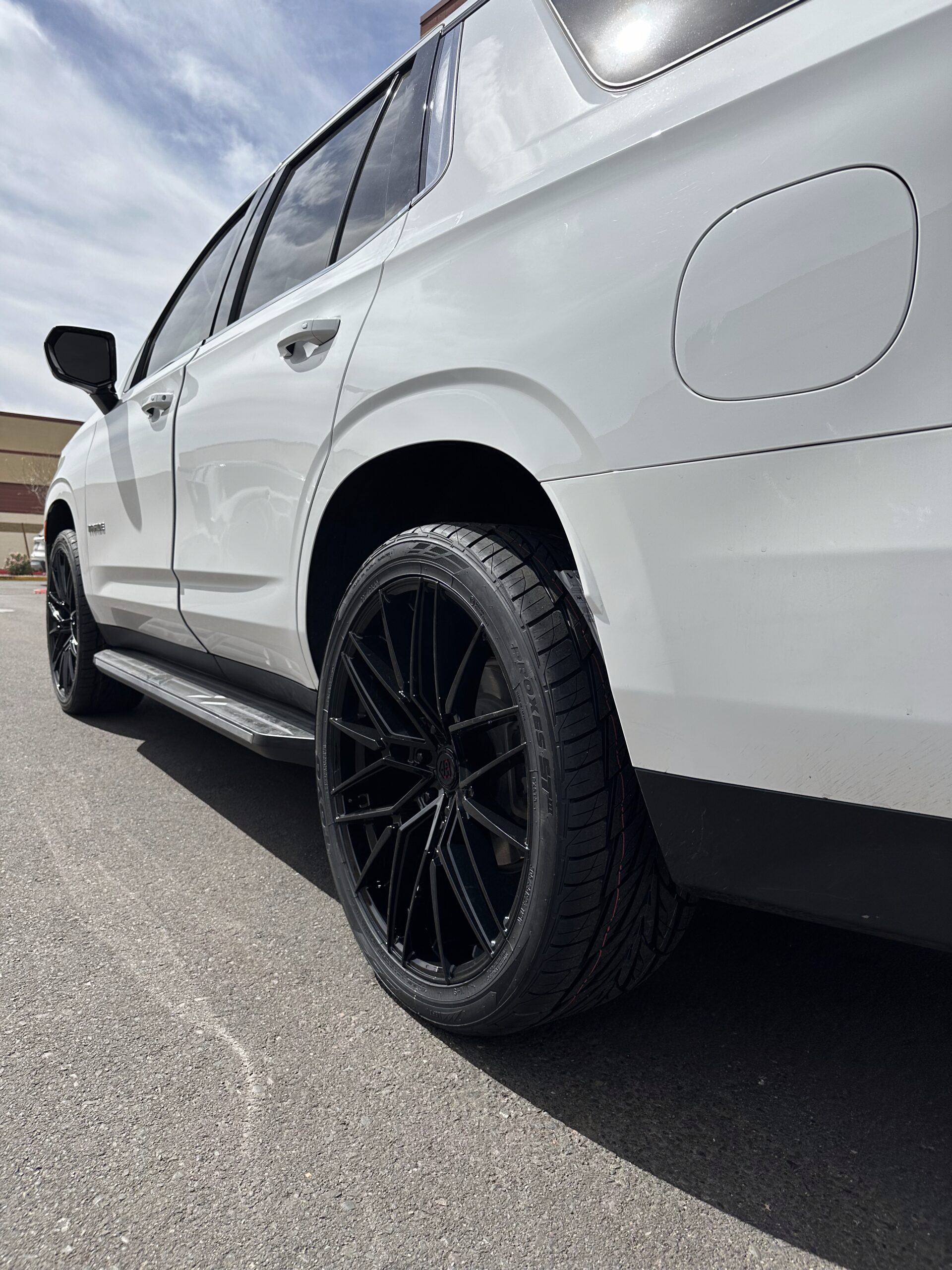 White SUV showing wheel and tire clearance at the rear fender