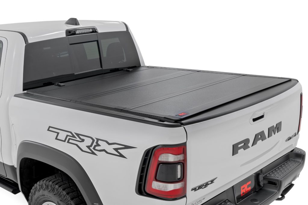 Rough Country Hard Tri-Fold Flip Up Fold Bed Cover 5β7β³ Bed Ram 1500 (19-26)/1500 TRX (21-24)